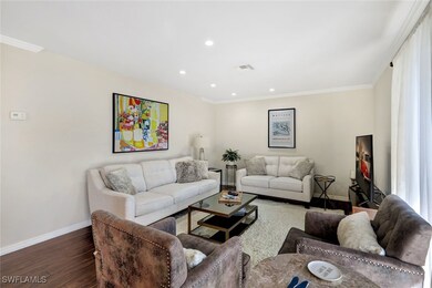 Living room featuring ornamental molding and dark