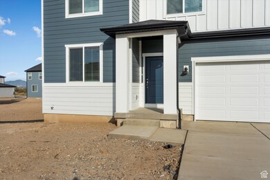 Doorway to property featuring board and batten siding and a garage
