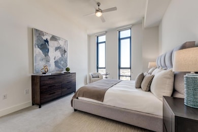 Bedroom featuring baseboards, light carpet, and ce