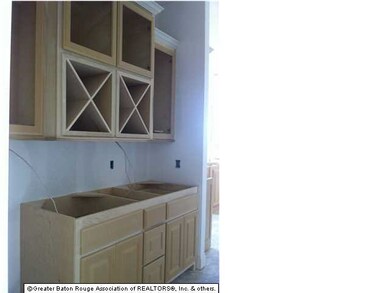 Bar with wine storage and glass front cabinets conveniently located between kitchen and formal dining area