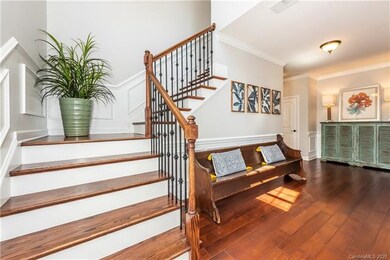 Beautiful foyer with hardwood floors and elegant s
