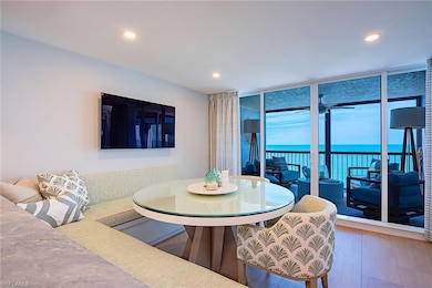 Dining area with floor to ceiling windows, wood finished floors, and recessed lighting