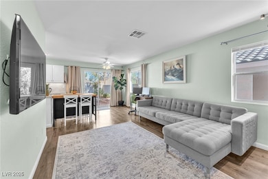 Living room featuring ceiling fan and wood finishe
