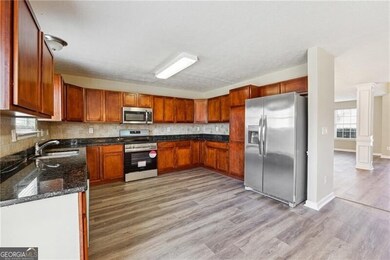 Kitchen with decorative columns, appliances with s