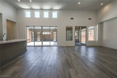 Great Room with soaring ceilings and two sliding d