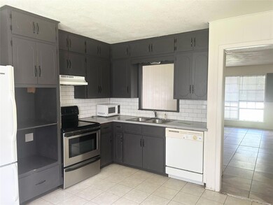 Kitchen featuring white appliances, under cabinet