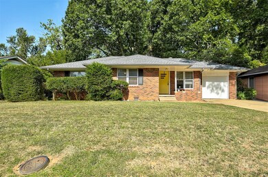 Single story home featuring a garage and a front y