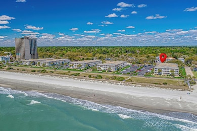 Aerial view featuring a water view and a beach view