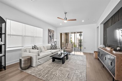 Living area with light wood-type flooring, recessed lighting, and a ceiling fan