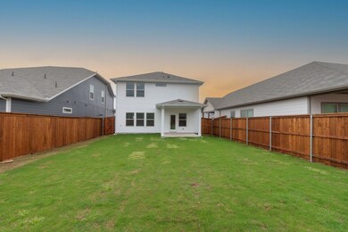 Rear view of property featuring a fenced backyard 
