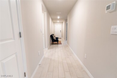 Corridor with light wood-type flooring