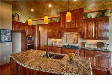 Huge granite island workspace with bookcases at ea