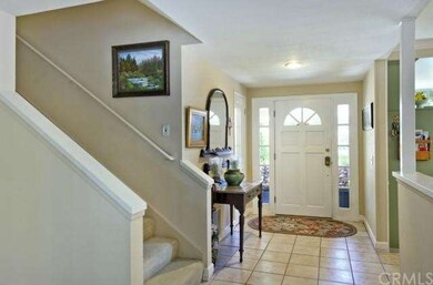 Front door with dual sidelights & tiled entry.