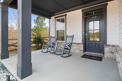 View of exterior entry featuring covered porch