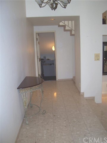 Marble floor entry.  Door leads to 2 car garage
