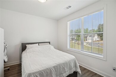 Bedroom featuring baseboards, dark wood-type floor