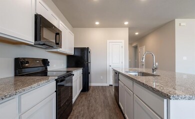 Kitchen featuring a center island with sink, whit