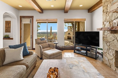 Living room featuring beamed ceiling, plenty of n