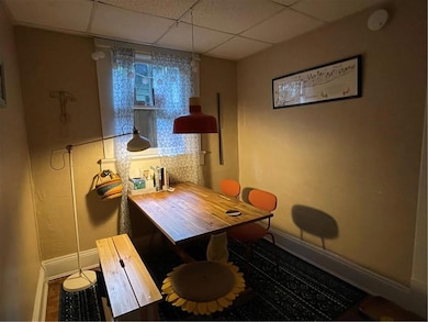 Dining room with a drop ceiling and baseboards