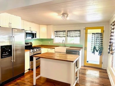 Kitchen featuring stainless steel appliances, woo