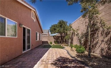 Fenced backyard with a patio area