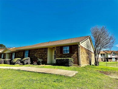 Ranch-style home featuring a front lawn and brick 