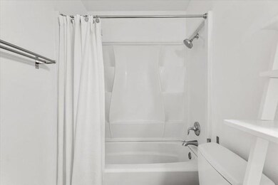 Bathroom with toilet and shower / tub combo