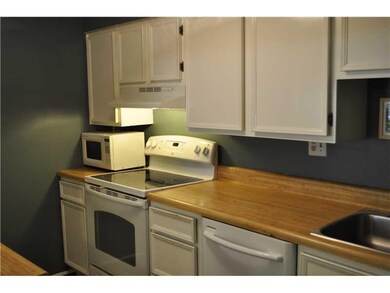 Kitchen. The dishwasher and dark wood laminate flo