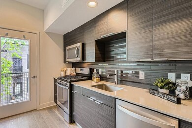Kitchen with stainless steel appliances, a sink, 