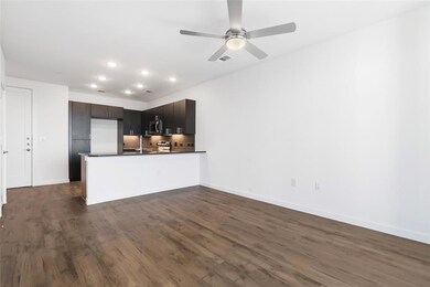 Kitchen featuring a peninsula, dark countertops, decorative backsplash, dark wood-style floors, and recessed lighting