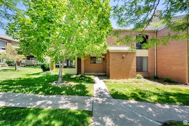 View of front of home featuring brick siding and a front lawn