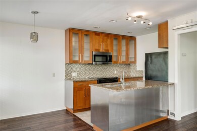 Kitchen with stainless steel microwave, brown cab