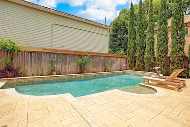 Beautiful pool setting with lounging area, fountai