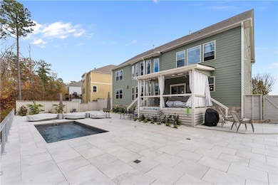 Rear view of house featuring a fenced backyard, a patio, and a gate