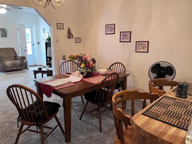 Carpeted dining area with ceiling fan with notable