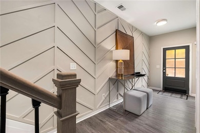Entrance foyer featuring dark wood-style flooring and baseboards