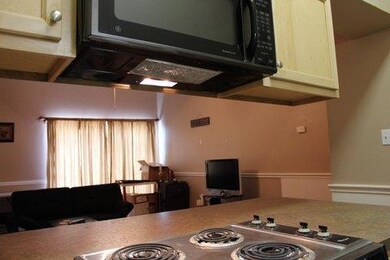 Kitchen with black microwave and light countertops