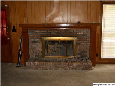 den upstairs with a fire place