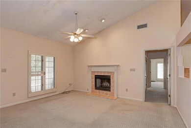 Unfurnished living room featuring baseboards, visi