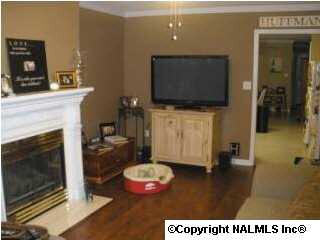 ANOTHER VIEW OF LIVING ROOM SHOWING LAMINATE WOOD FLOOR.