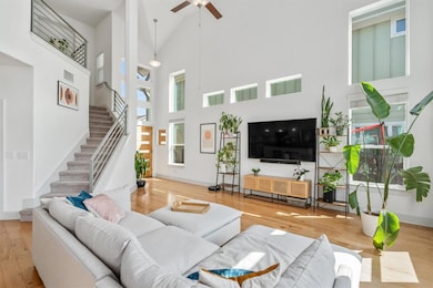 Living room featuring high vaulted ceiling, wood 