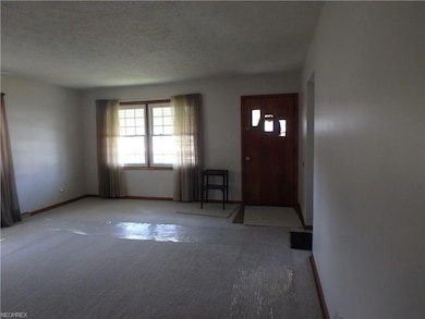 Living room featuring new carpet, hardwood floors 
