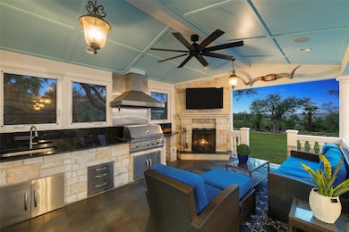 View of patio with a sink, a grill, ceiling fan, 