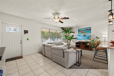 Living room featuring ceiling fan, a textured ceil