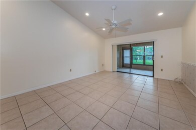 Large living room with tile floors, ceiling fan an