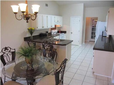 View of the kitchen from the breakfast nook. Beautiful GRANITE countertops & deep stainless steel sink really dress up this kitchen! .