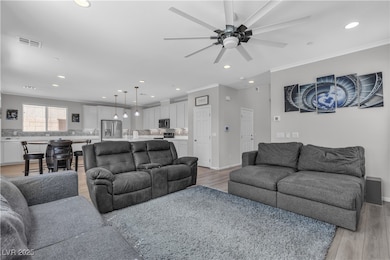 Living area featuring crown molding, baseboards, c