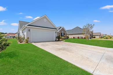 View of front of property with a garage, roof with