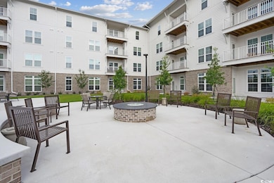 View of home's community with an outdoor fire pit