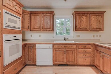 Kitchen with hardwood floor and backyard view